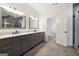 Bathroom featuring double vanity sinks with modern fixtures and bright lighting at 4186 Matisse Ln, Fairburn, GA 30213