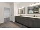 Bathroom featuring double vanity sinks with modern fixtures and bright lighting at 4186 Matisse Ln, Fairburn, GA 30213