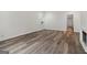 Inviting bedroom with wood-look floors, large window, and neutral walls leading to a walk-in closet at 4186 Matisse Ln, Fairburn, GA 30213