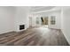 Spacious bedroom featuring wood-look flooring, fireplace, trey ceilings, and natural light from windows and a door at 4186 Matisse Ln, Fairburn, GA 30213