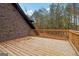 Wooden deck overlooking a wooded backyard, perfect for outdoor relaxation and entertaining at 4186 Matisse Ln, Fairburn, GA 30213