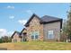 Stunning home featuring a stone and brick facade, complemented by a well-manicured front lawn at 4186 Matisse Ln, Fairburn, GA 30213