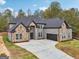 Handsome two-story brick home featuring a spacious driveway, attached garage, and professionally landscaped yard at 4186 Matisse Ln, Fairburn, GA 30213