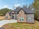 Striking two-story brick home featuring a spacious driveway, attached garage, and beautifully landscaped yard at 4186 Matisse Ln, Fairburn, GA 30213
