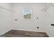 Bright laundry room with modern flooring and ample space for appliances at 4186 Matisse Ln, Fairburn, GA 30213
