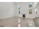 Bright living room with fireplace, complemented by gleaming tiled floors, offers a cozy, inviting space at 4186 Matisse Ln, Fairburn, GA 30213