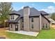 This home features a covered porch and patio with a brick exterior, complemented by an expansive lawn at 4186 Matisse Ln, Fairburn, GA 30213