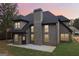Charming rear exterior featuring a brick facade, well-maintained lawn, and a cozy outdoor space perfect for relaxation at 4186 Matisse Ln, Fairburn, GA 30213