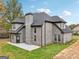 This home features a covered porch and patio with a brick exterior, complemented by an expansive lawn at 4186 Matisse Ln, Fairburn, GA 30213