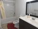 Bathroom featuring a shower-tub combo and a dark wood vanity at 6570 Laurens Way, Stone Mountain, GA 30087