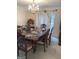 Dining room with a large table, chandelier, and bright natural light at 6570 Laurens Way, Stone Mountain, GA 30087