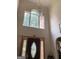 Grand foyer with a tall window, ornate light fixture, and decorative front door at 6570 Laurens Way, Stone Mountain, GA 30087