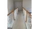 Bright hallway with white walls, neutral carpet, and white railing with wood trim at 6570 Laurens Way, Stone Mountain, GA 30087