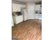 This kitchen features wood vinyl flooring and white cabinets at 6570 Laurens Way, Stone Mountain, GA 30087