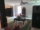 Living room with a ceiling fan, flower arrangement and a plush green rug at 6570 Laurens Way, Stone Mountain, GA 30087