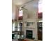 Vaulted ceiling living room features a fireplace, large mirror, and grand windows at 6570 Laurens Way, Stone Mountain, GA 30087
