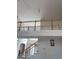Upstairs hallway overlooking a living room with a fireplace and large mirror at 6570 Laurens Way, Stone Mountain, GA 30087