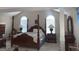 The main bedroom boasts high ceilings, large windows, and a four-poster bed at 6570 Laurens Way, Stone Mountain, GA 30087