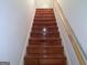 A stairway with hardwood steps and a wood handrail at 6570 Laurens Way, Stone Mountain, GA 30087