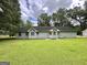 View of the exterior of the home showcasing the expansive, lush backyard at 150 Willow Shoals Dr, Covington, GA 30016