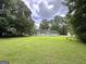 Exterior view of a home on a well-maintained lawn with scattered mature trees at 150 Willow Shoals Dr, Covington, GA 30016
