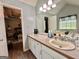 En-suite bathroom with great natural light, a vanity, and the bedroom in the background at 150 Willow Shoals Dr, Covington, GA 30016