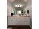 Bathroom vanity with double sinks and ample storage in a well-lit bathroom at 150 Willow Shoals Dr, Covington, GA 30016