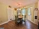 Cozy dining area with hardwood floors, stylish chandelier, and seating for four at 150 Willow Shoals Dr, Covington, GA 30016