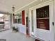 Charming covered front porch with seasonal decor and seating creating an inviting entrance at 150 Willow Shoals Dr, Covington, GA 30016