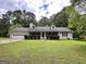 Charming one-story home with attached garage and well-manicured lawn at 150 Willow Shoals Dr, Covington, GA 30016