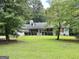 Welcoming one-story home with dormer windows and spacious front yard at 150 Willow Shoals Dr, Covington, GA 30016