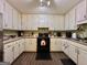 This is a kitchen with white cabinets, black appliances and a wood floor at 150 Willow Shoals Dr, Covington, GA 30016