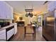 This kitchen boasts wood floors, a stainless steel refrigerator, and view to other rooms at 150 Willow Shoals Dr, Covington, GA 30016