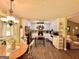 Kitchen boasts wood floors, a dining area, view to the living room and white cabinetry at 150 Willow Shoals Dr, Covington, GA 30016