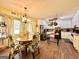 Eat-in kitchen features wood floors, white cabinets, stainless steel refrigerator and matching black appliances at 150 Willow Shoals Dr, Covington, GA 30016