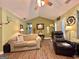 Bright living room with hardwood floors, comfortable seating, and plenty of natural light at 150 Willow Shoals Dr, Covington, GA 30016