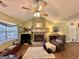 Inviting living room featuring a cozy stone fireplace, ceiling fan, and comfortable seating at 150 Willow Shoals Dr, Covington, GA 30016