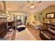 Open living room with fireplace, ceiling fan, hardwood floors, and neutral décor at 150 Willow Shoals Dr, Covington, GA 30016