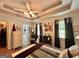 The main bedroom features a tray ceiling, fan, nice furniture and a large window at 150 Willow Shoals Dr, Covington, GA 30016