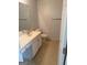 Well-lit bathroom with a single sink, toilet, vanity, and modern vinyl flooring, creating a functional and stylish space at 1925 Cedar Walk Ln, Conley, GA 30288
