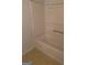 Bathroom featuring a bathtub with tile surround, along with updated vinyl flooring, offering comfort and style at 1925 Cedar Walk Ln, Conley, GA 30288