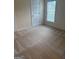 Cozy bedroom featuring carpet, a window for natural light, and a door providing easy access at 1925 Cedar Walk Ln, Conley, GA 30288