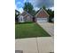 Charming single-Gathering home featuring a well-manicured lawn and a two-car garage at 1925 Cedar Walk Ln, Conley, GA 30288