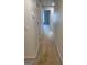 Hallway leading to other rooms, featuring neutral carpet and walls, connecting various parts of the house at 1925 Cedar Walk Ln, Conley, GA 30288