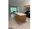 Eat-in kitchen with center island, black appliances, and tile floors at 1925 Cedar Walk Ln, Conley, GA 30288