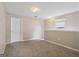 Bonus room with carpet, white trim and baseboards, and a small window at 7813 Newbury Dr, Jonesboro, GA 30236