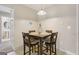 A cozy dining area features a square table with four chairs, illuminated by a pendant light fixture at 7813 Newbury Dr, Jonesboro, GA 30236