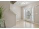 Bright foyer featuring a front door with glass panels, neutral walls, and tiled flooring, offering a welcoming entrance at 7813 Newbury Dr, Jonesboro, GA 30236