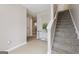 The Foyer welcomes you with neutral tones, a carpeted staircase, and a glass console table, creating an inviting ambiance at 7813 Newbury Dr, Jonesboro, GA 30236