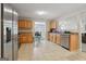A kitchen with stainless steel appliances and wooden cabinets offers sightlines into the dining and living areas at 7813 Newbury Dr, Jonesboro, GA 30236